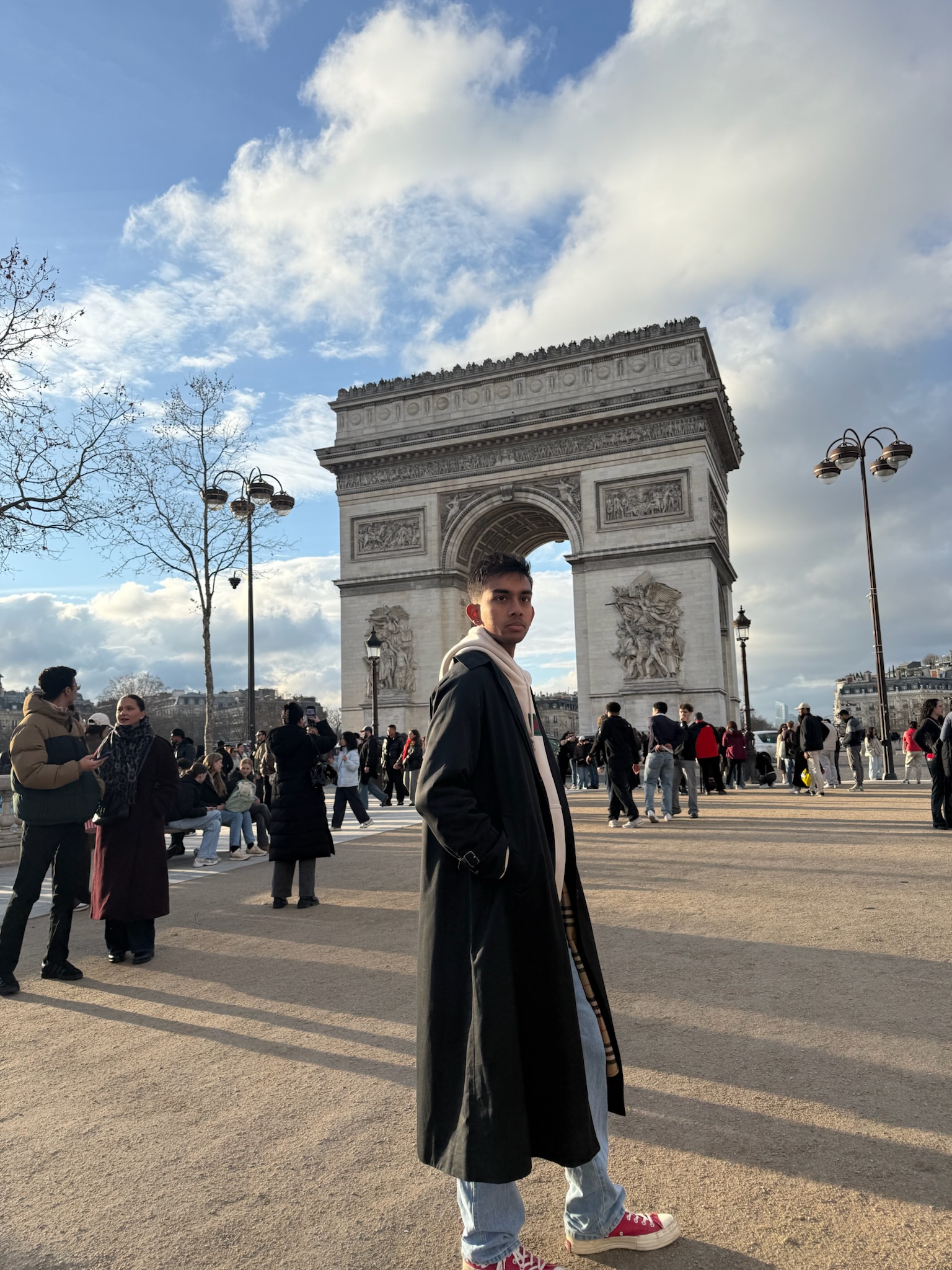 Rohit Satish standing in front of the Arc de Triomphe